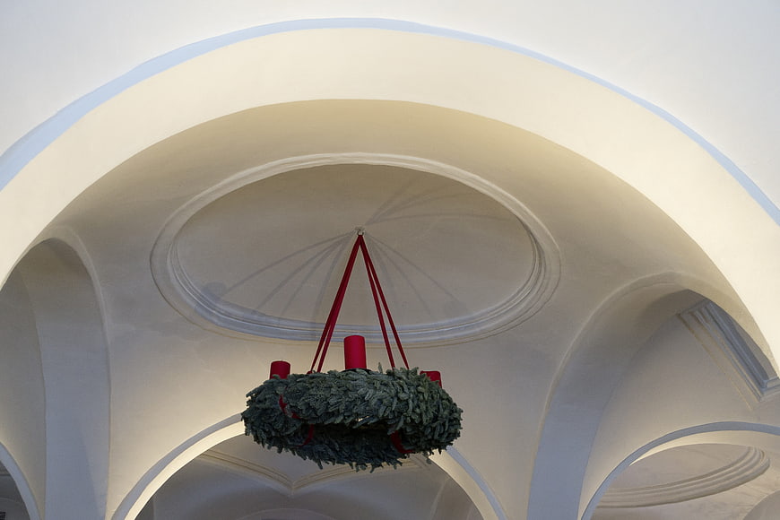 Hanging Advent Wreath with Red Candles in White Vaulted Ceiling