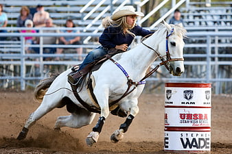 Cowgirl Riding White Horse In Barrel Racing Competition