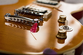 Close-up of Vintage Electric Guitar Body with Pick and Toggle Switch