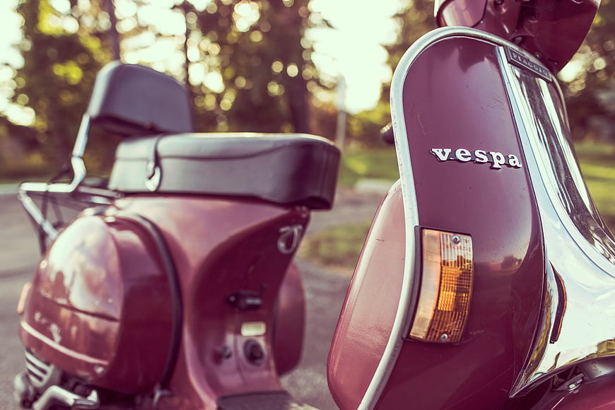Close-up of Vintage Red Vespa Scooter in Park