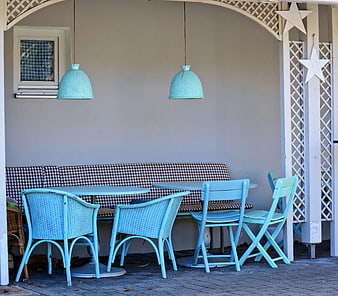 Light blue patio furniture with checkered bench and hanging lamps