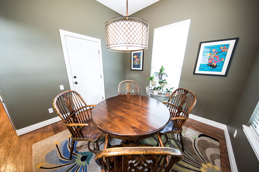 Modern dining room with wooden table and gray walls