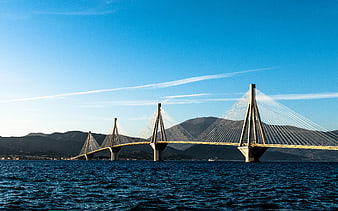 Rion-Antirion Bridge spanning the sea with mountains in background