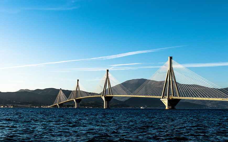 Rion-Antirion Bridge spanning the sea with mountains in background