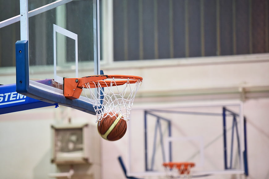 Basketball Ball Swishing Through Net In Indoor Court