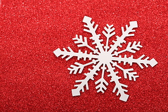 White Snowflake Ornament On Red Glitter Background