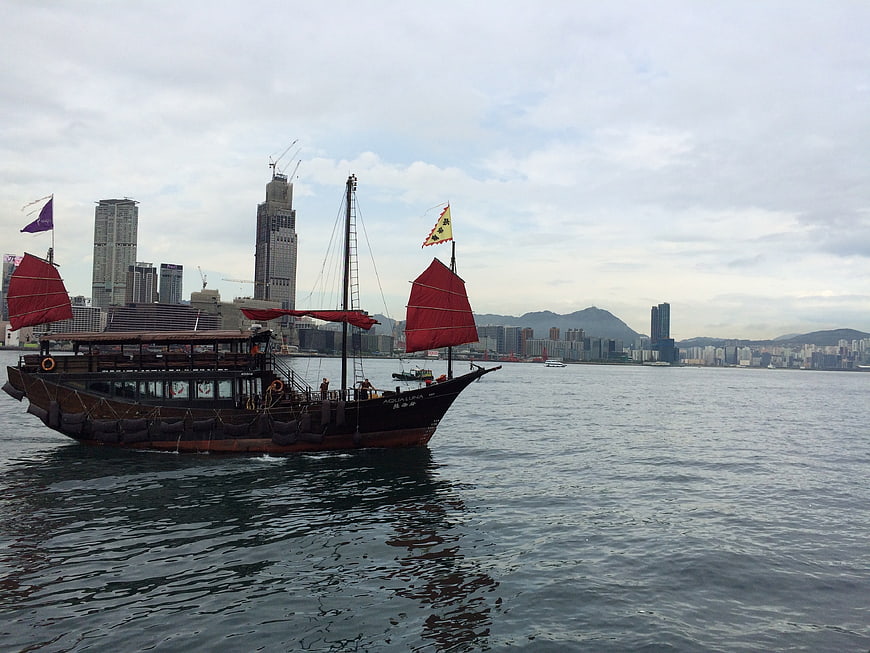 Traditional Chinese Junk Boat Sailing in Hong Kong Harbor