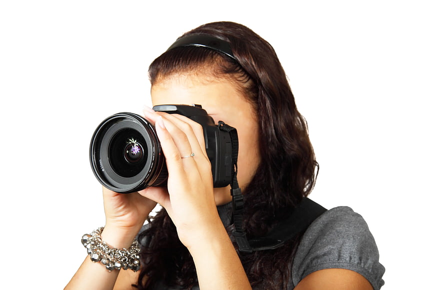 Woman Photographer Holding DSLR Camera on White Background