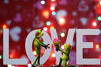 Cute Green Frog Figurines Presenting Roses Against LOVE Text