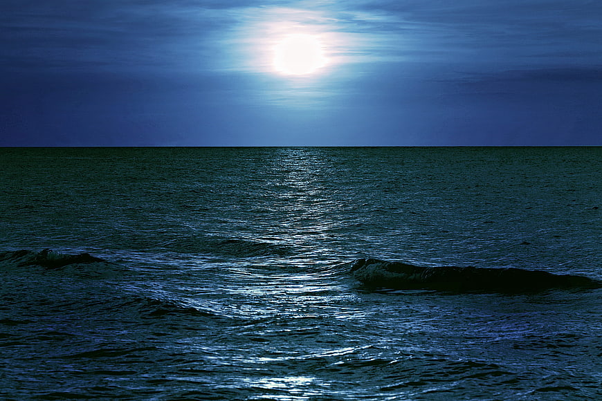 Moonlight Reflection on Dark Sea Horizon at Night
