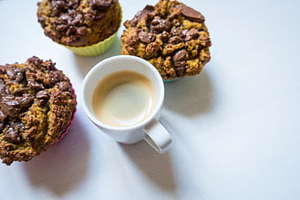 Homemade chocolate muffins with espresso coffee on white background