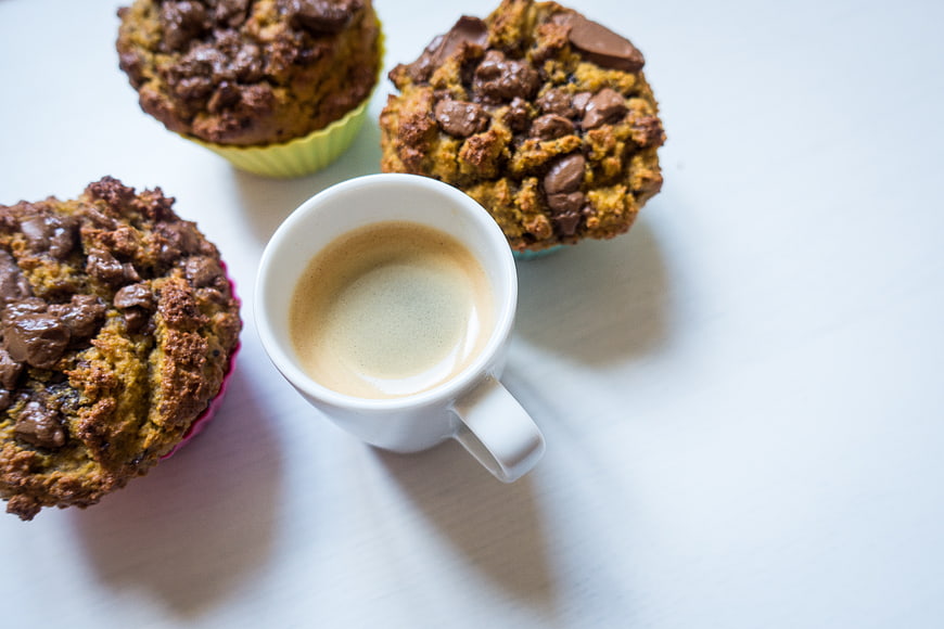 Homemade chocolate muffins with espresso coffee on white background