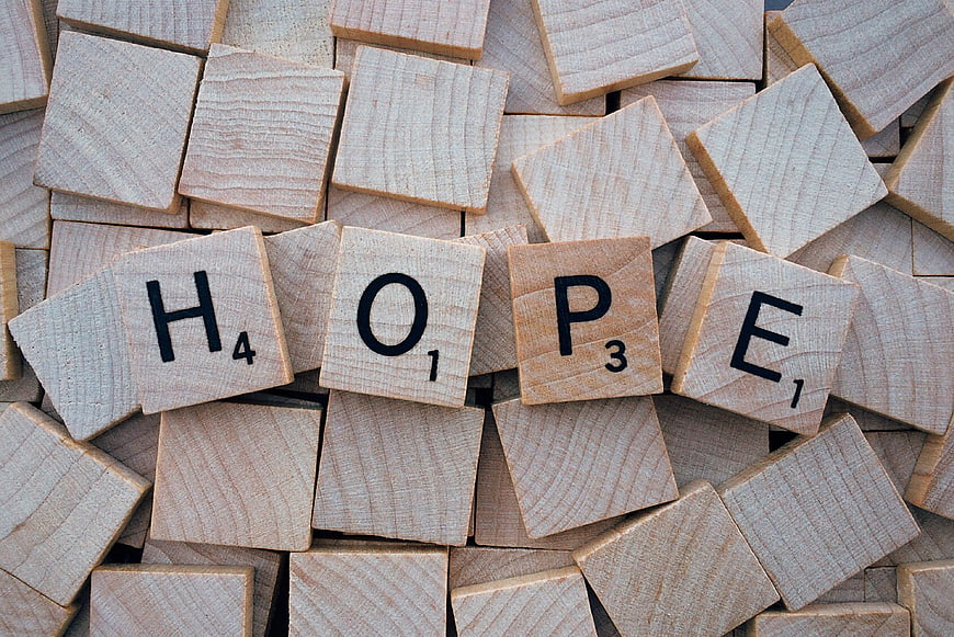 Wooden Scrabble Tiles Spelling Hope on Pile