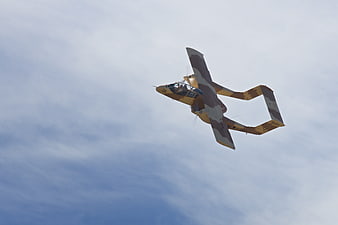 Unique Camouflaged Aircraft Flying Against Blue Sky