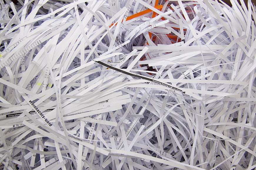 Close-up of shredded paper strips in a recycling bin