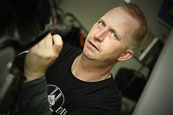 Mechanic inspecting motorcycle engine with intense focus