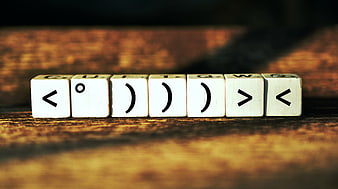Scrabble Tiles Spelling Smiley Face On Wooden Table