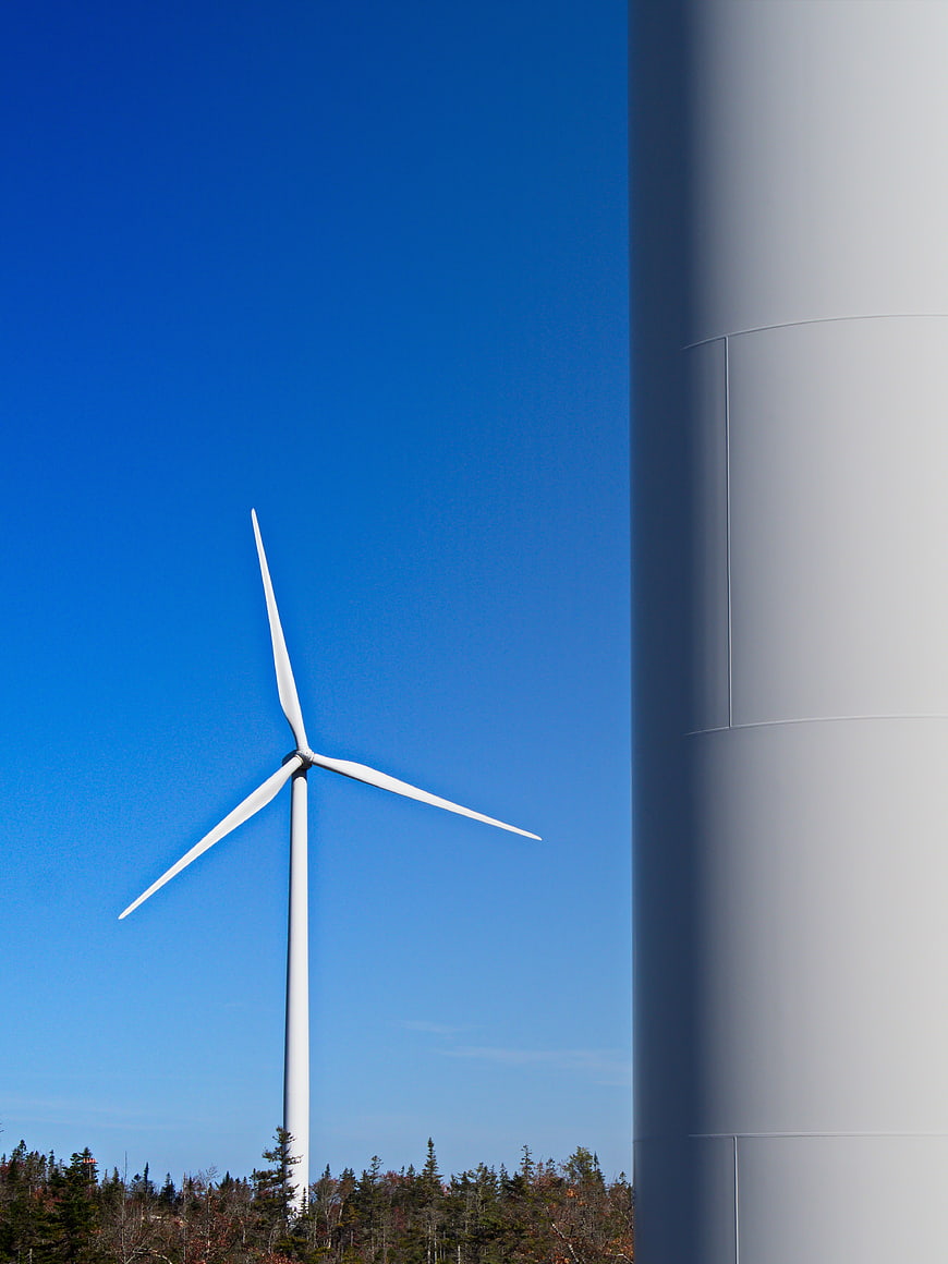 White Wind Turbine Against Blue Sky