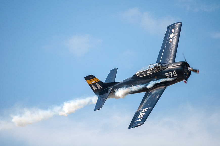 Vintage Navy T-6 Texan Airplane Performing Aerobatic Maneuver
