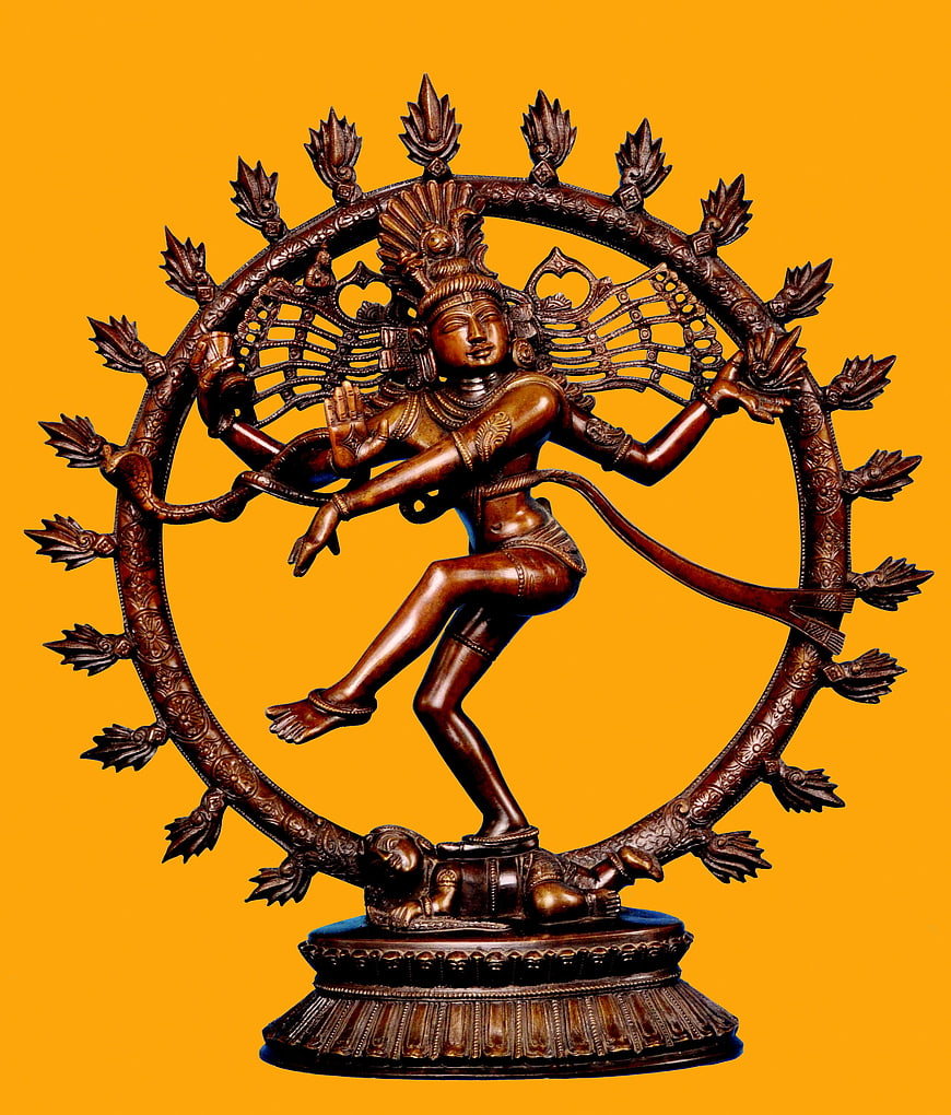 Nataraja bronze statue of Shiva dancing on orange background