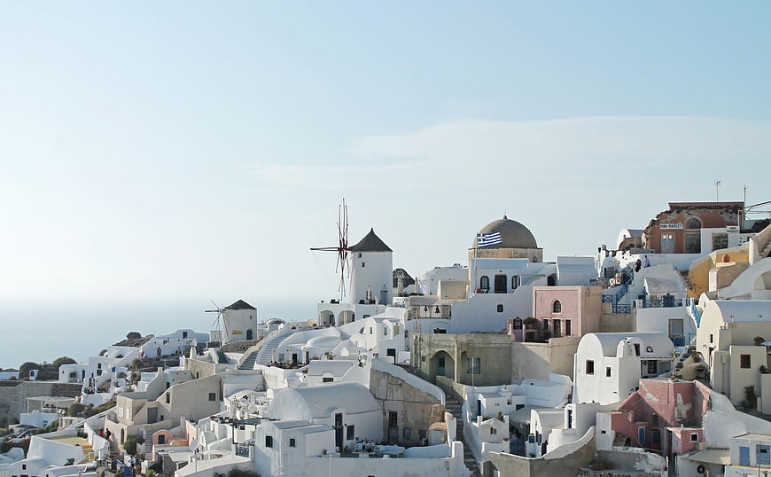 Santorini Windmills and White Buildings with Greek Flag