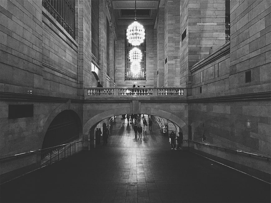 Black and white architecture of grand hall with chandeliers