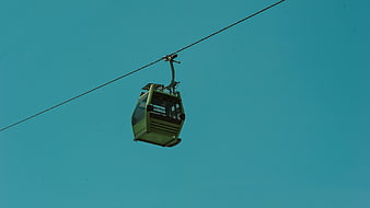 Green Cable Car Against Minimalist Teal Sky