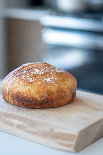 Fresh Artisan Sourdough Bread Loaf on Wooden Board
