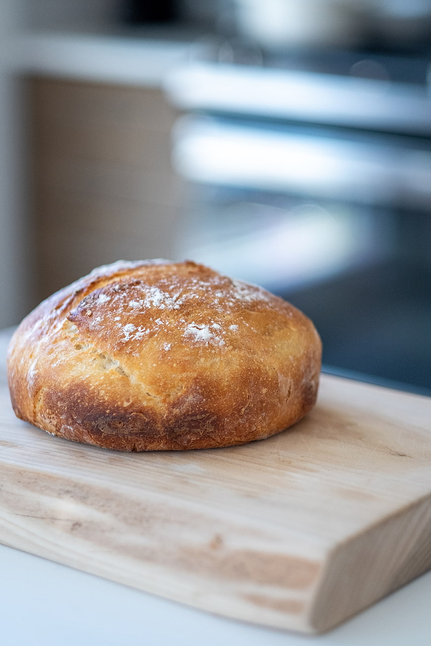Fresh Artisan Sourdough Bread Loaf on Wooden Board