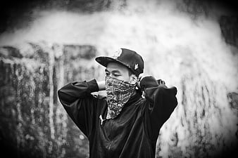 Young man in streetwear with bandana mask and cap