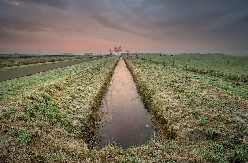 Frosty Canal in Rural Landscape at Sunset
