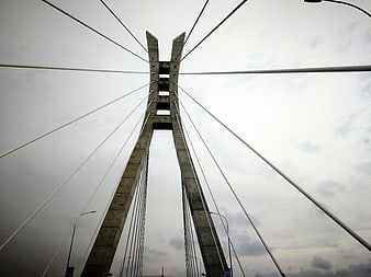 Low angle view of modern cable-stayed bridge tower