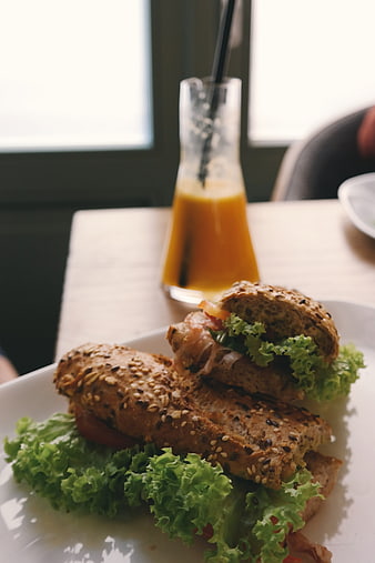 Healthy Sandwich with Lettuce and Orange Juice in Cafe
