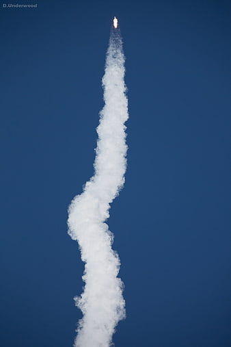 Rocket Launch Trail Against Deep Blue Sky