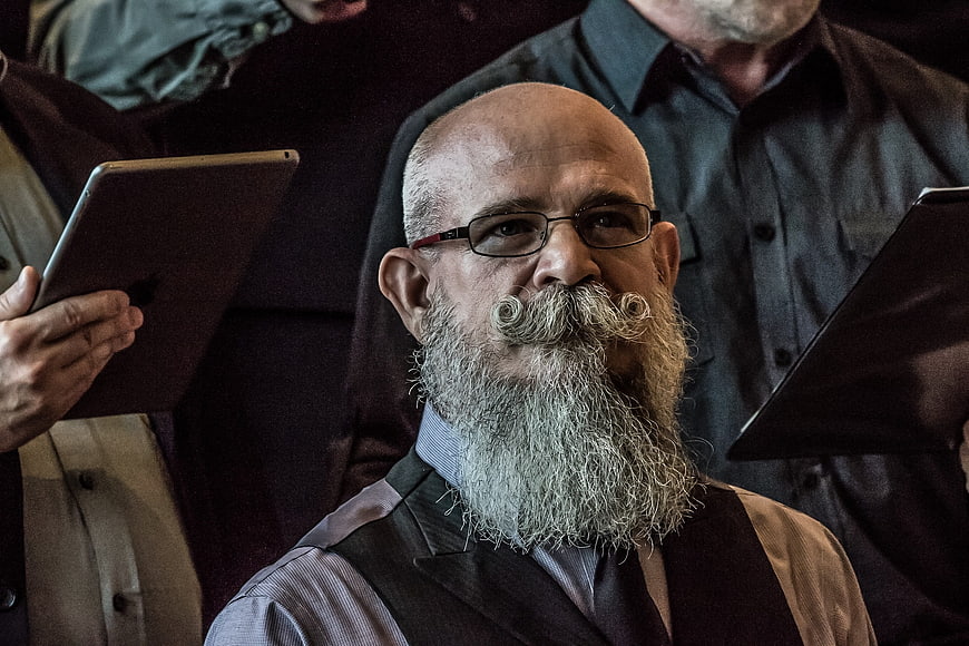 Portrait of elderly man with distinctive handlebar mustache and beard