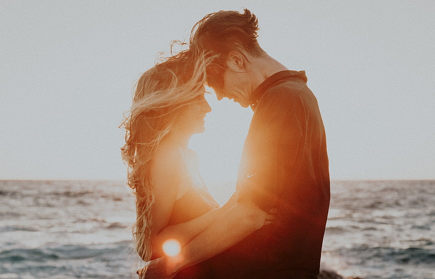 Romantic Couple Embracing on Beach at Sunset