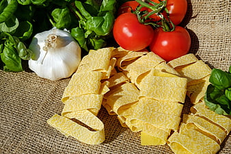 Fresh Tagliatelle Pasta with Tomatoes, Basil, and Garlic on Burlap