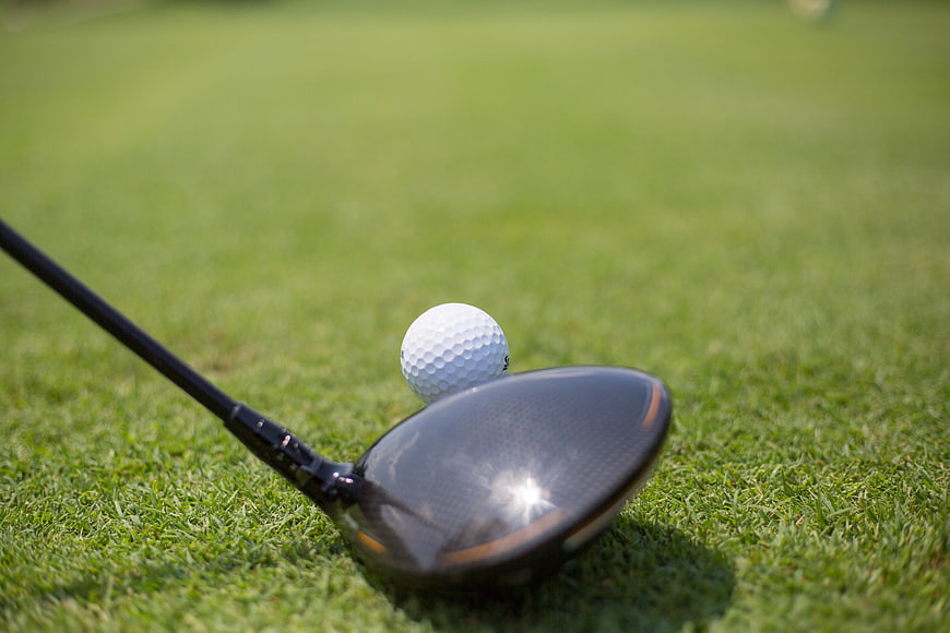 Golf Driver and Ball on Green Grass
