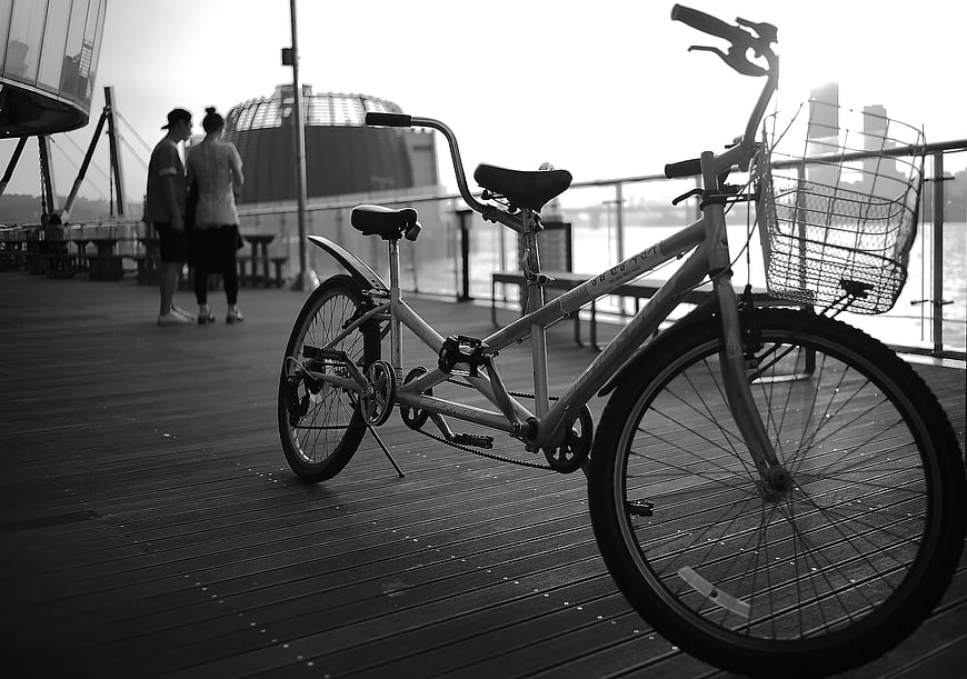 Black and White Tandem Bicycle on Wooden Pier