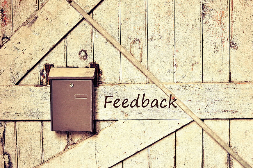 Rustic wooden feedback box on weathered barn door