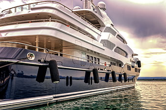 Luxury Yacht Docked at Sunset with Dramatic Sky