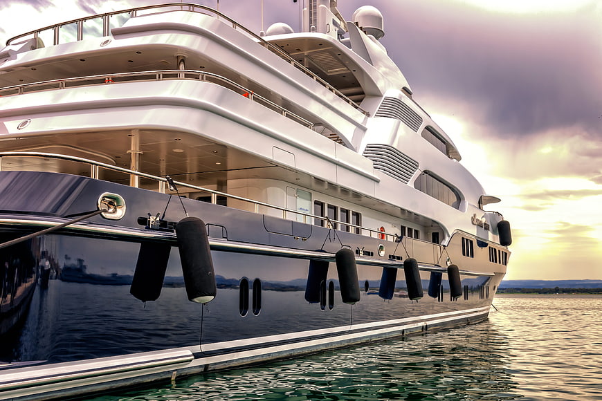 Luxury Yacht Docked at Sunset with Dramatic Sky