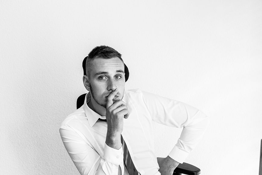 Black and white portrait of a young businessman thinking
