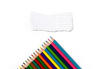 Colorful Pencils and Graph Paper on White Background