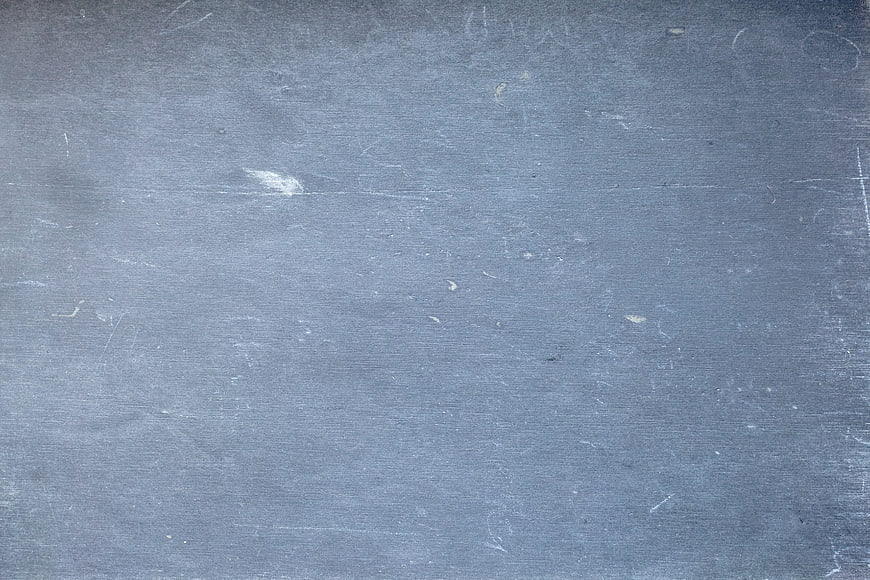 Empty Dark Chalkboard Texture With Faint Chalk Marks And Scratches