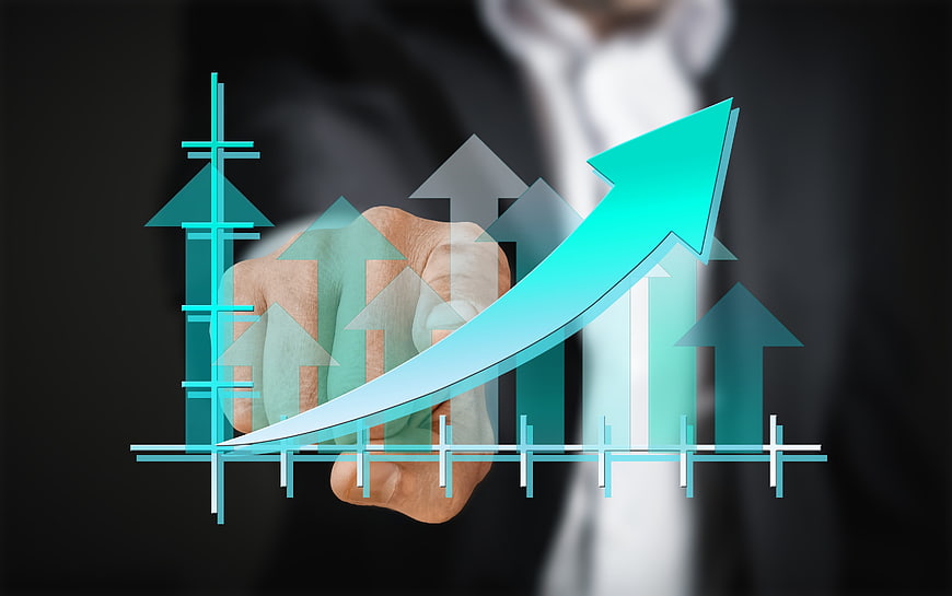 Businessman drawing growth arrow on digital screen