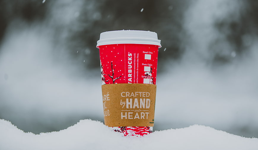 Red Starbucks Coffee Cup in Snowy Winter Landscape