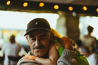 Emotional Portrait of Senior Man Hugging Child