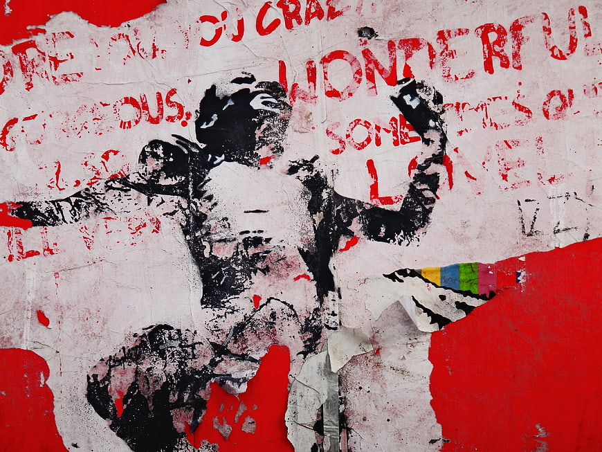 Weathered Street Art Mural With Red Text And Black Figure