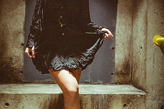 Woman in Black Dress on Concrete Stairs
